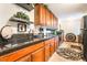 Kitchen with sleek black countertops, wooden cabinets, and decorative accents at 750 S Royal Crest Cir # 317, Las Vegas, NV 89169
