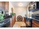 Cozy kitchen featuring wood cabinets, black appliances, and stylish decorations creating a warm, inviting culinary space at 750 S Royal Crest Cir # 317, Las Vegas, NV 89169