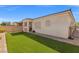 Beautifully landscaped backyard with artificial grass, covered patio, and privacy fencing at 8668 Marcana St, Las Vegas, NV 89166