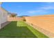 Spacious backyard with well-maintained artificial turf and a privacy wall at 8668 Marcana St, Las Vegas, NV 89166