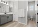 Well-lit bathroom with a modern vanity, toilet, and tiled flooring at 8668 Marcana St, Las Vegas, NV 89166