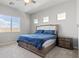 Bright bedroom featuring a large window and comfortable bed with stylish blue bedding at 8668 Marcana St, Las Vegas, NV 89166