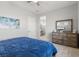 Bedroom view showcasing a window, dresser, and ensuite bathroom for added privacy at 8668 Marcana St, Las Vegas, NV 89166