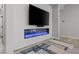 Close up of a modern fireplace with a television, adding a stylish touch to the living space at 8668 Marcana St, Las Vegas, NV 89166