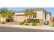 Well-maintained single-story home featuring a two-car garage, desert landscaping, and a paved driveway at 8668 Marcana St, Las Vegas, NV 89166