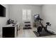 Home gym featuring modern equipment, a desk area, and natural light at 8668 Marcana St, Las Vegas, NV 89166