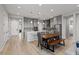 This spacious kitchen features stainless steel appliances, a large island and a hardwood table at 8668 Marcana St, Las Vegas, NV 89166