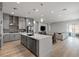 Bright, open-concept kitchen featuring stainless appliances, a large island, and hardwood flooring at 8668 Marcana St, Las Vegas, NV 89166