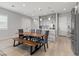 Kitchen and dining area featuring wood table with grey chairs, grey cabinetry, stainless steel appliances and island at 8668 Marcana St, Las Vegas, NV 89166