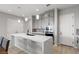 Modern kitchen features grey cabinetry, stainless steel appliances, white countertops and stylish pendant lighting at 8668 Marcana St, Las Vegas, NV 89166