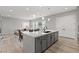 A bright living space, features a large kitchen island and an open layout to the living area at 8668 Marcana St, Las Vegas, NV 89166
