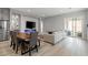Open-concept space combines dining and living areas, featuring hardwood floors and modern decor at 8668 Marcana St, Las Vegas, NV 89166