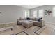 Living room featuring a comfortable sofa, wood floors, natural light, and modern décor at 8668 Marcana St, Las Vegas, NV 89166