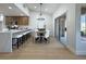Modern dining area open to kitchen, featuring sleek lighting and sliding glass doors to the outside at 9369 Villa Ridge Dr, Las Vegas, NV 89134