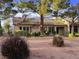 Charming home with a well-manicured lawn, mature trees, and a tiled roof at 9369 Villa Ridge Dr, Las Vegas, NV 89134