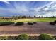 Overlook the picturesque golf course from the backyard; manicured lawns and stunning sky at 9369 Villa Ridge Dr, Las Vegas, NV 89134