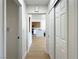 View down the long hallway showing the kitchen, white walls, light vinyl floors and closet space at 9369 Villa Ridge Dr, Las Vegas, NV 89134