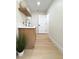 Bright laundry area with overhead shelf, modern sink, and view down an elongated hallway at 9369 Villa Ridge Dr, Las Vegas, NV 89134