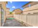 The backyard has a nice patio area with rock landscaping and a privacy fence at 978 Valetta Flat Ave, Las Vegas, NV 89183