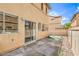 Spacious backyard with concrete patio, artificial turf, and a sliding glass door entrance at 978 Valetta Flat Ave, Las Vegas, NV 89183