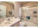Cozy bathroom featuring a shower-tub combo with sliding glass doors and single sink vanity at 978 Valetta Flat Ave, Las Vegas, NV 89183