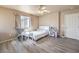 Bedroom with neutral walls, plank flooring, ceiling fan, and natural light at 978 Valetta Flat Ave, Las Vegas, NV 89183