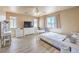 Bedroom with neutral walls, plank flooring, ceiling fan, and natural light at 978 Valetta Flat Ave, Las Vegas, NV 89183