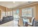 Open-concept dining area with contemporary furniture, view of the living room, and natural light at 978 Valetta Flat Ave, Las Vegas, NV 89183