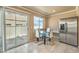 Cozy dining area with a glass table, modern chairs, and sliding door at 978 Valetta Flat Ave, Las Vegas, NV 89183
