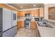 Well-lit kitchen featuring stainless steel appliances and wood cabinets at 978 Valetta Flat Ave, Las Vegas, NV 89183