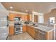 Well-lit kitchen with stainless steel appliances and wood cabinetry providing ample storage and a sleek design at 978 Valetta Flat Ave, Las Vegas, NV 89183