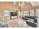 Spacious living room featuring high ceilings, large windows, and tile flooring at 978 Valetta Flat Ave, Las Vegas, NV 89183