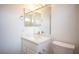 Bright bathroom with a marble vanity, white walls, and a toilet at 10321 Marymont Pl, Las Vegas, NV 89134