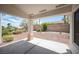 Comfortable covered patio with ample space for outdoor seating overlooking the landscaped backyard at 10321 Marymont Pl, Las Vegas, NV 89134