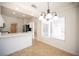 An eat-in kitchen dining nook features a chandelier and bright natural light next to the kitchen at 10321 Marymont Pl, Las Vegas, NV 89134