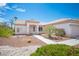 Inviting front exterior with desert landscaping, walkway, and colorful flowering bushes at 10321 Marymont Pl, Las Vegas, NV 89134