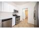Modern kitchen featuring white cabinets and stainless steel appliances at 10321 Marymont Pl, Las Vegas, NV 89134