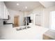 Modern kitchen with white cabinets, stainless steel appliances, and quartz countertops at 10321 Marymont Pl, Las Vegas, NV 89134