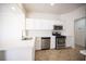 Modern kitchen featuring white cabinets, stainless steel appliances, and quartz countertops at 10321 Marymont Pl, Las Vegas, NV 89134