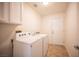 Laundry room featuring cabinets and tiled floors at 10321 Marymont Pl, Las Vegas, NV 89134