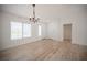 Inviting living room with modern wood flooring, large windows, and neutral walls at 10321 Marymont Pl, Las Vegas, NV 89134