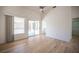 Bright living room featuring wood floors, vaulted ceiling, and sliding glass door to backyard at 10321 Marymont Pl, Las Vegas, NV 89134
