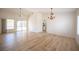 Bright and airy living room with stylish wood flooring, ceiling fan, and sliding glass door to the backyard at 10321 Marymont Pl, Las Vegas, NV 89134
