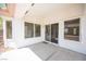 Covered patio with multiple windows and a sliding glass door offering a seamless indoor-outdoor transition at 10321 Marymont Pl, Las Vegas, NV 89134