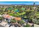 Nevada home with a view of blue lakes and a lush green golf course from above on a sunny day at 1034 Tam O Shanter, Las Vegas, NV 89109