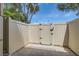 A fenced-in backyard offers privacy with neutral-toned fencing and gravel ground cover at 1034 Tam O Shanter, Las Vegas, NV 89109