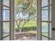 Picturesque view from a balcony overlooking a lush golf course, framed by elegant white doors at 1034 Tam O Shanter, Las Vegas, NV 89109