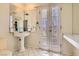 Bathroom with pedestal sink, tiled floors, and window offering natural light at 1034 Tam O Shanter, Las Vegas, NV 89109