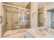 Well-lit bathroom featuring a shower-tub combo with sliding glass doors and a vanity with ample counter space at 1034 Tam O Shanter, Las Vegas, NV 89109