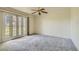 The main bedroom features plush carpeting and bright glass doors to the outside at 1034 Tam O Shanter, Las Vegas, NV 89109